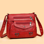 Women's Multi-Pocket Shoulder Bag with Heart Hardware and Front Zip Pockets