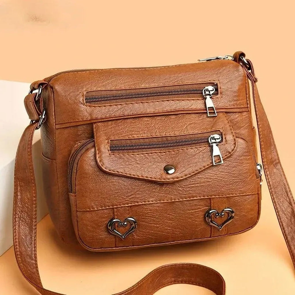 Women's Multi-Pocket Shoulder Bag with Heart Hardware and Front Zip Pockets