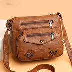 Women's Multi-Pocket Shoulder Bag with Heart Hardware and Front Zip Pockets