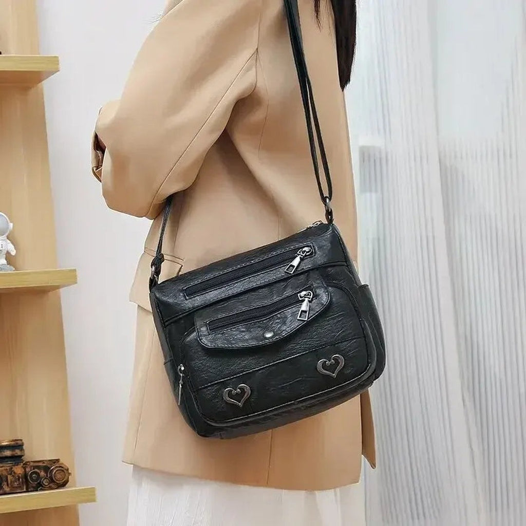 Women's Multi-Pocket Shoulder Bag with Heart Hardware and Front Zip Pockets