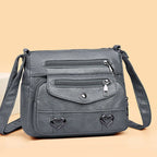 Women's Multi-Pocket Shoulder Bag with Heart Hardware and Front Zip Pockets