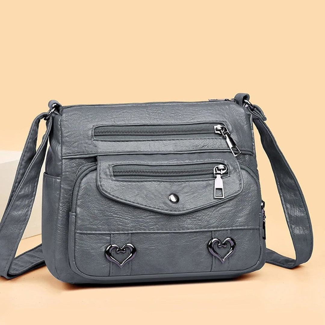 Women's Multi-Pocket Shoulder Bag with Heart Hardware and Front Zip Pockets